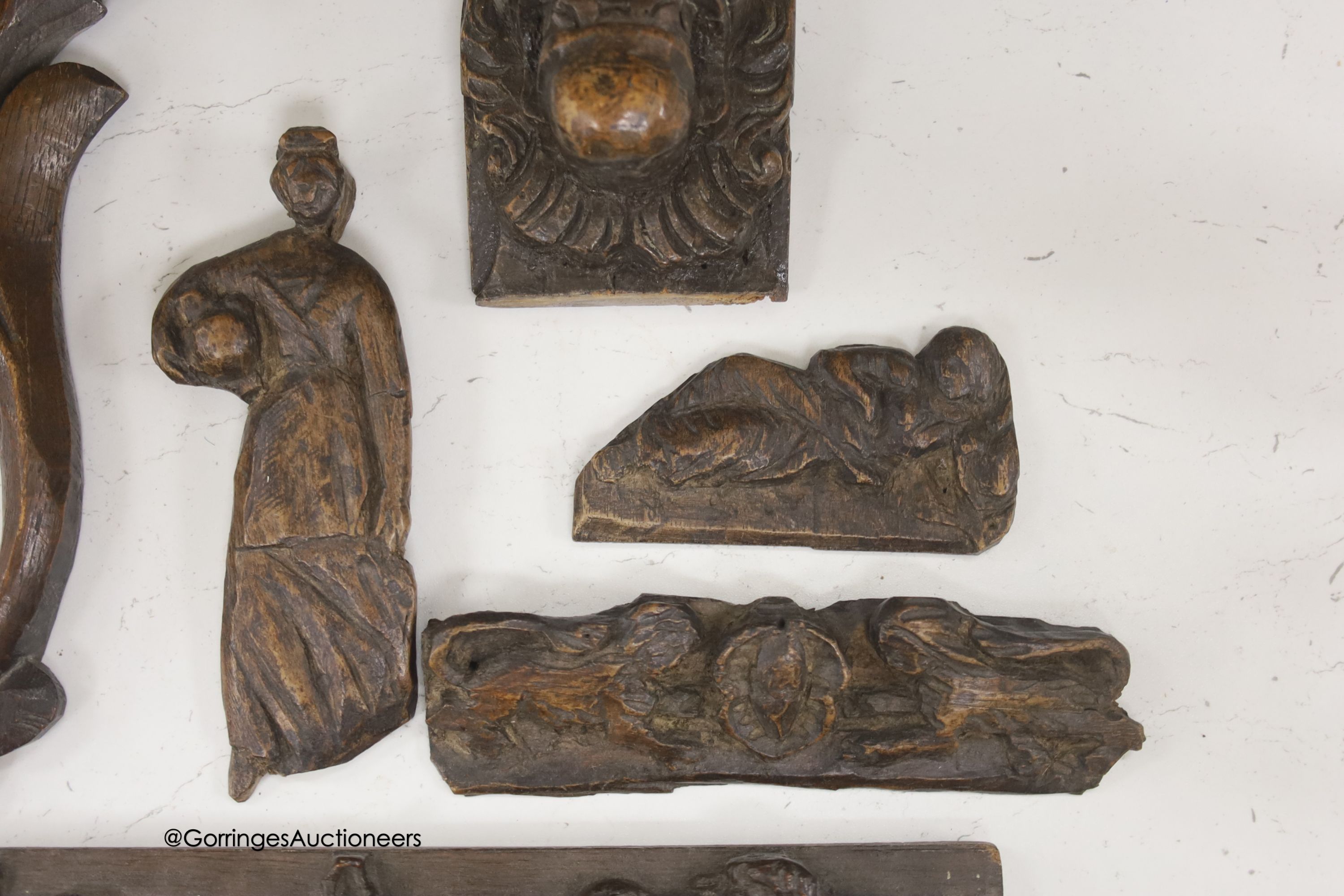Seven 17th century or later carved oak fragments including a pair of lion masks